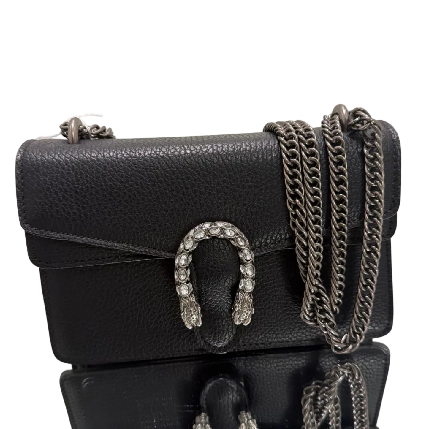 Black leather handbag with chain details and decorative buckles on a light background