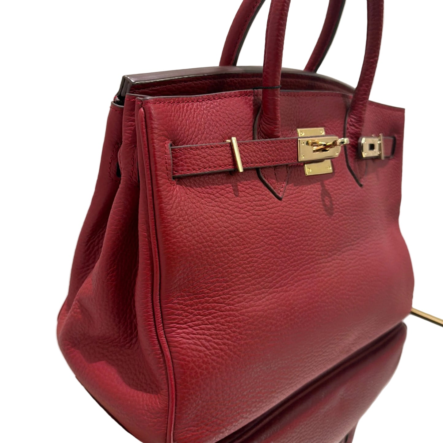 Red handbag with gold hardware on a white background