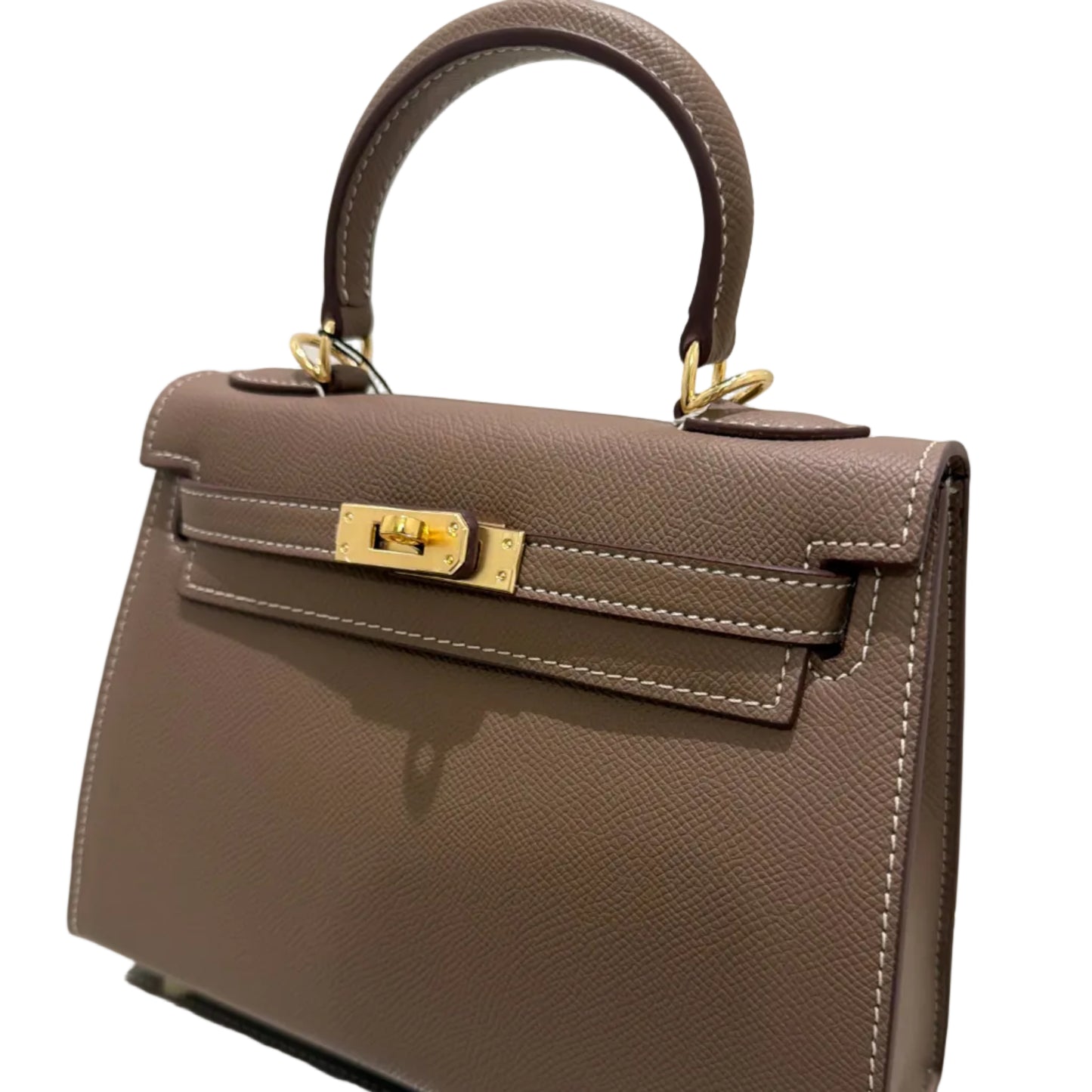 Brown handbag with gold accents on a light gray background
