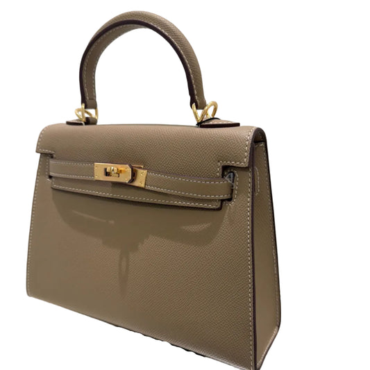 Gray handbag with gold accents on a white background