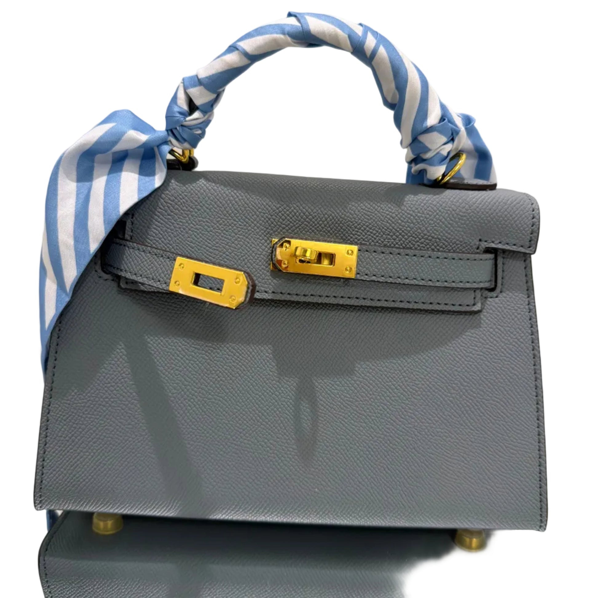 Gray handbag with blue and white striped handle on a light background