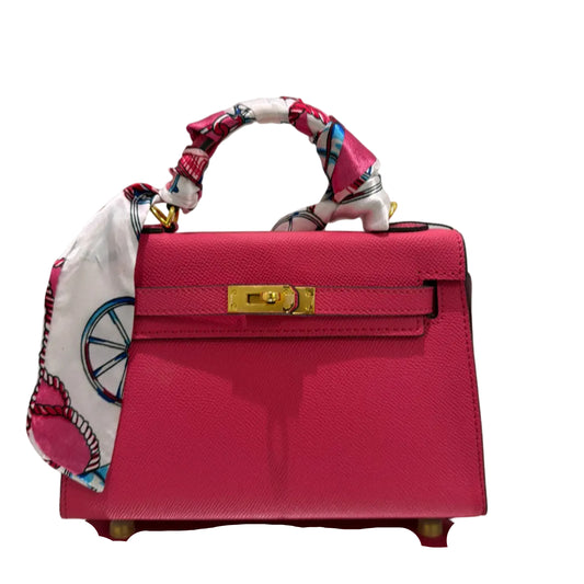 Red handbag with a colorful handle on a light gray background