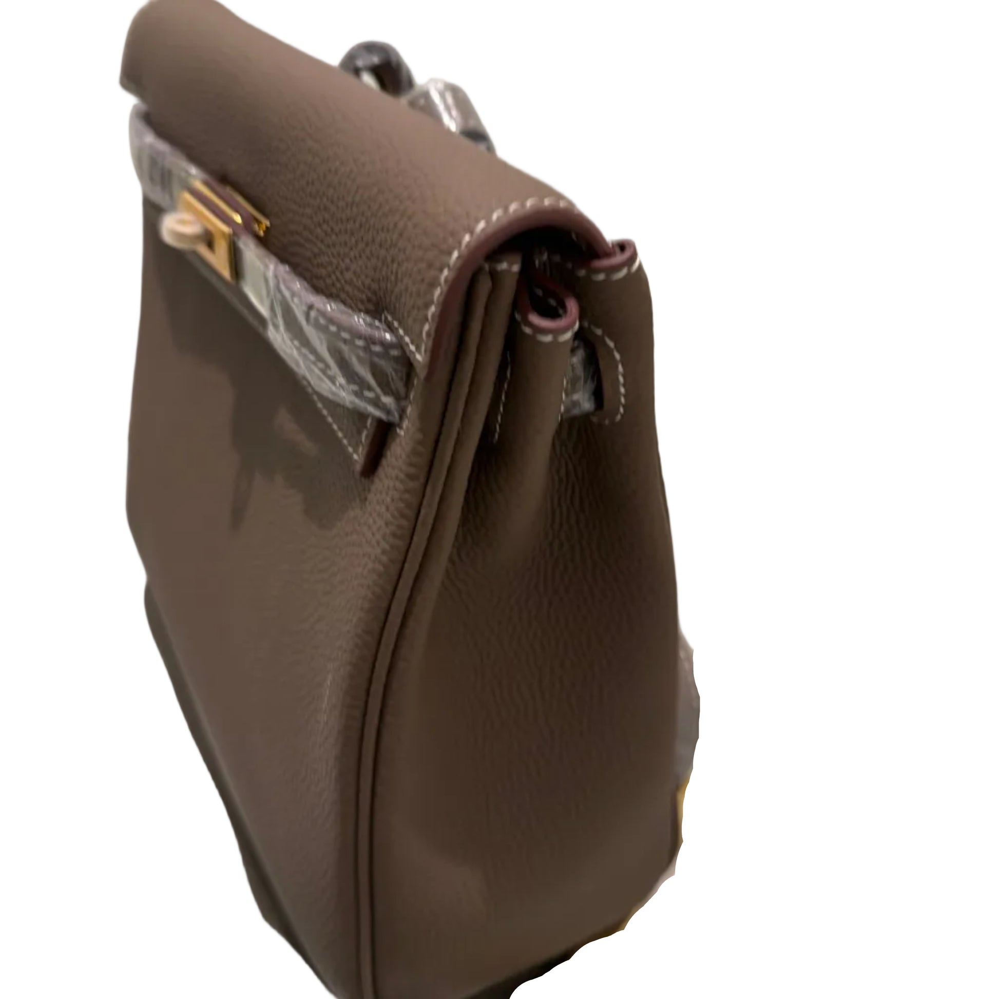 Brown leather handbag with gold accents on a white background