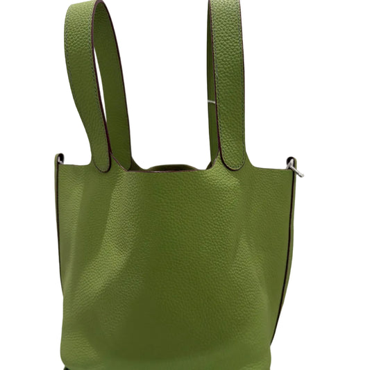 Green handbag with a strap on a white background