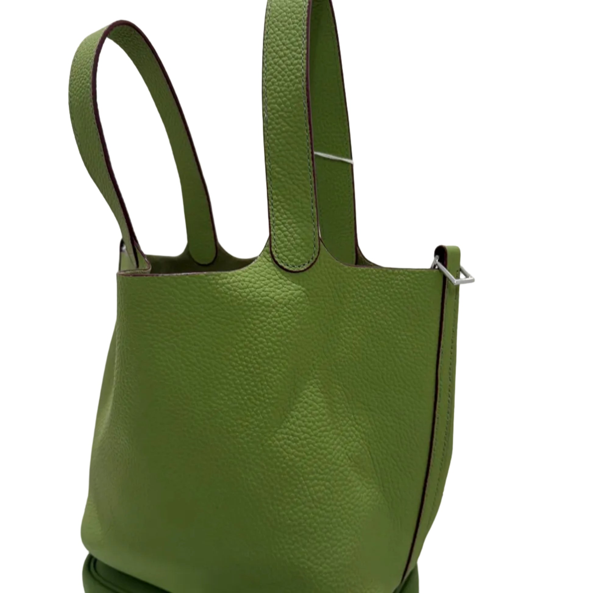 Green leather handbag with a reflective surface on a white background
