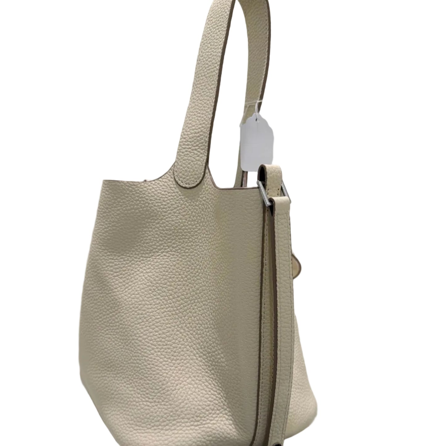 Beige handbag with a visible brand tag on a white background