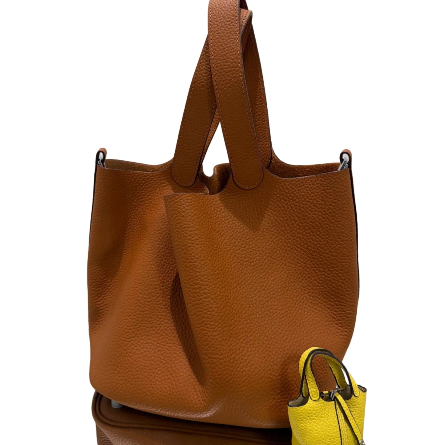 Brown leather handbag with a yellow strap on a white background