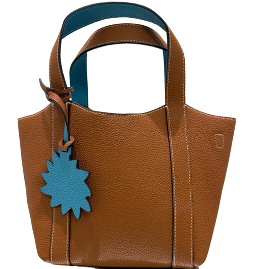 Brown leather bag with blue accents on a light background
