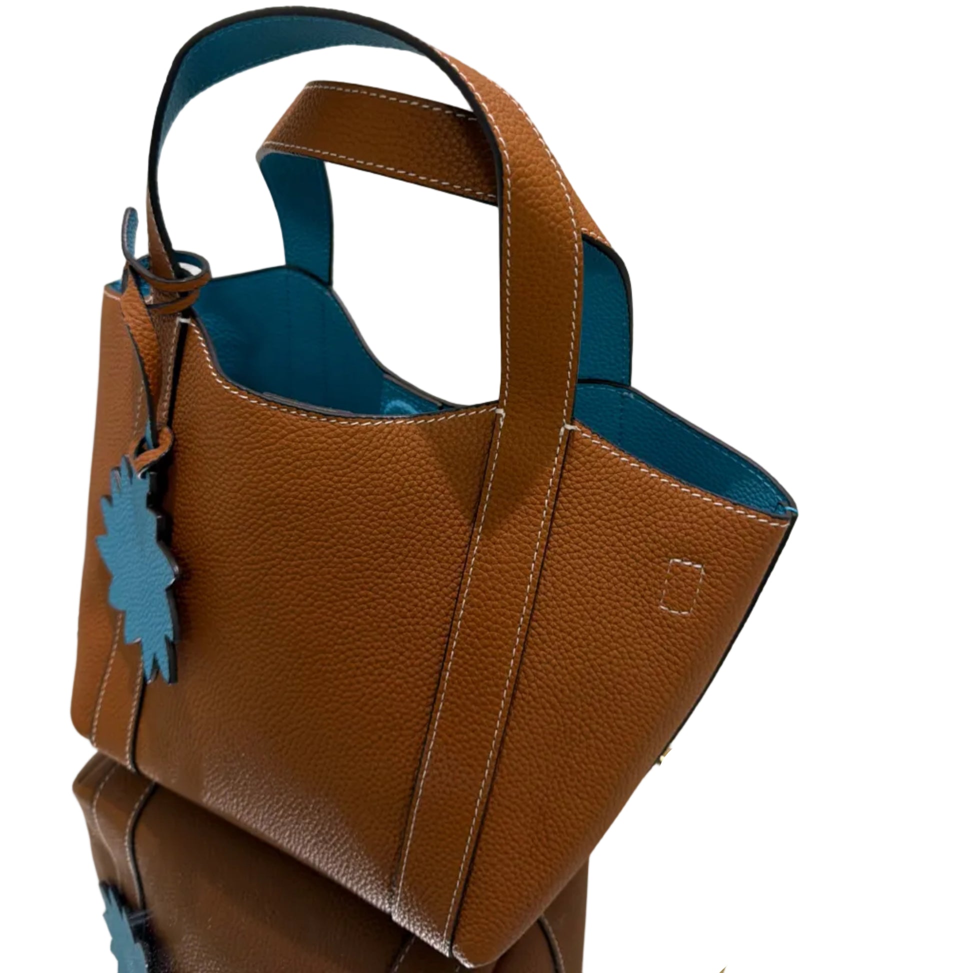 Brown leather bag with blue accents on a white background