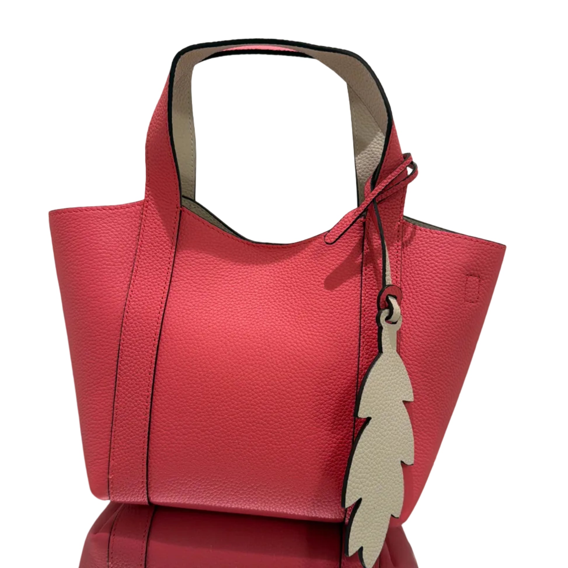 Red handbag with leaf designs on a white background