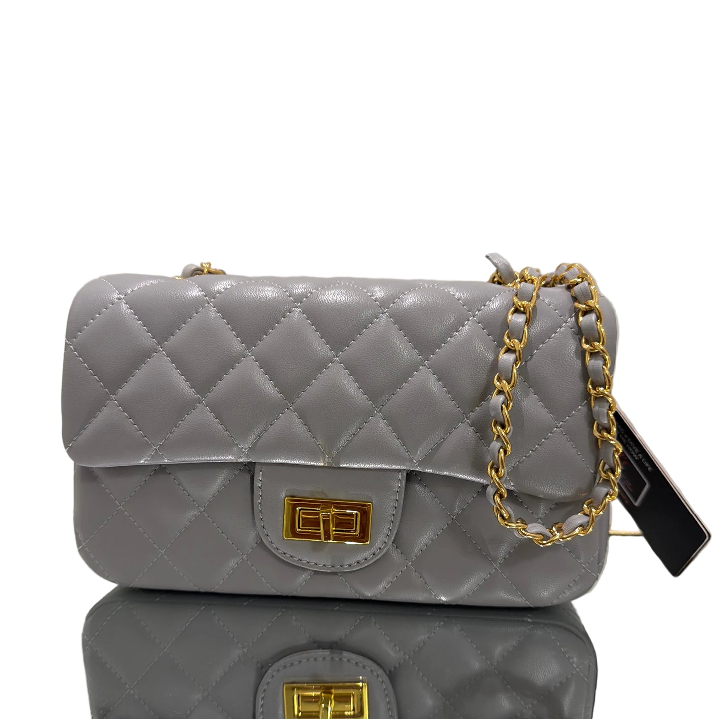 Two gray quilted handbags with gold chains and clasps on a light background
