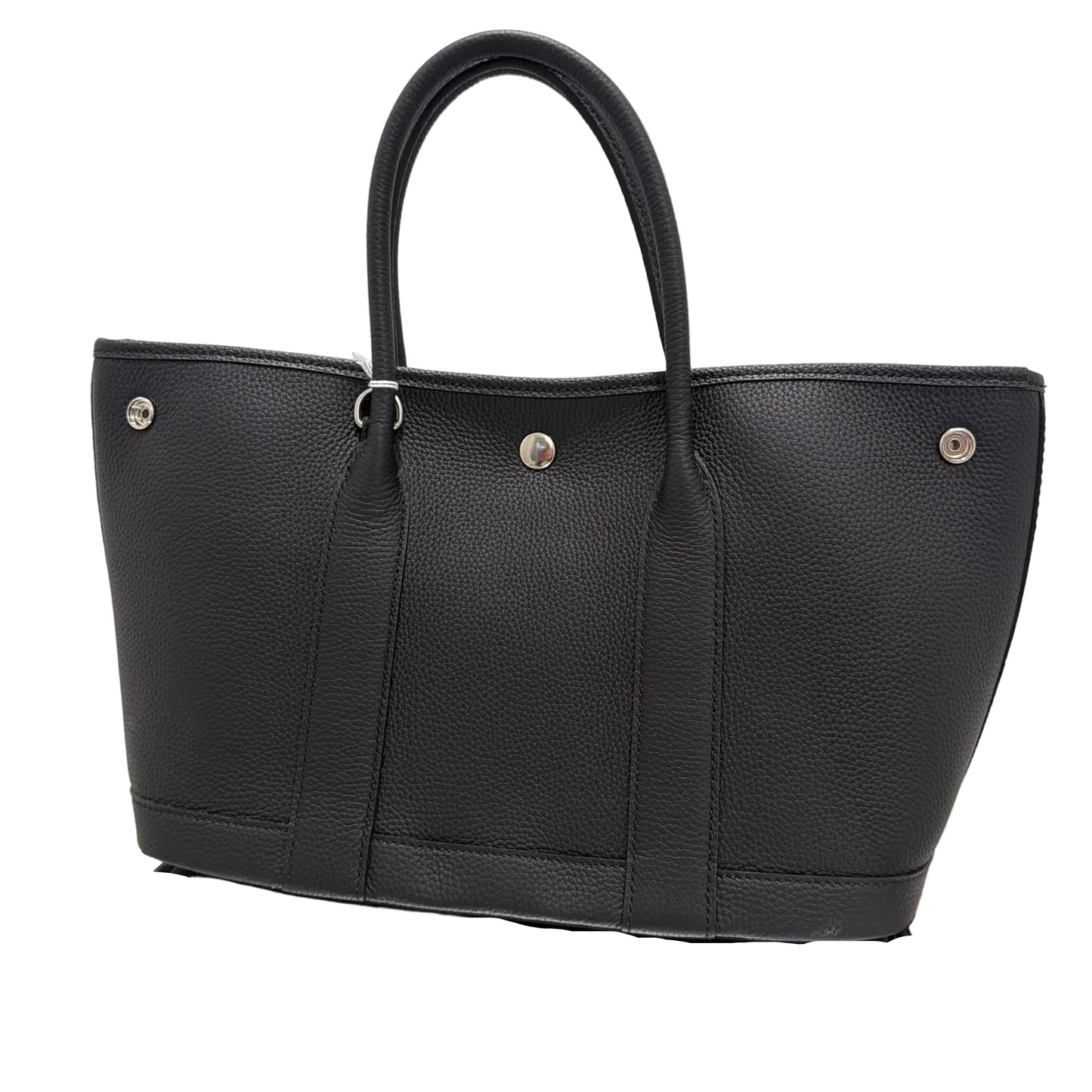 Black leather bag with silver buttons on a light background