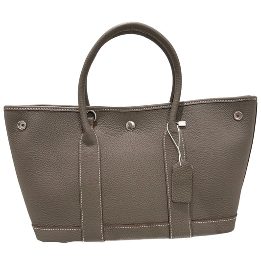 Gray leather briefcase with a mirror reflection on a light background