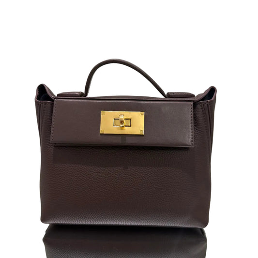 Brown leather handbag with gold clasp on a light gray background