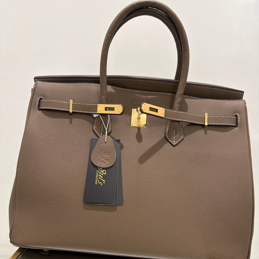 Brown leather briefcase with gold accents on a white background