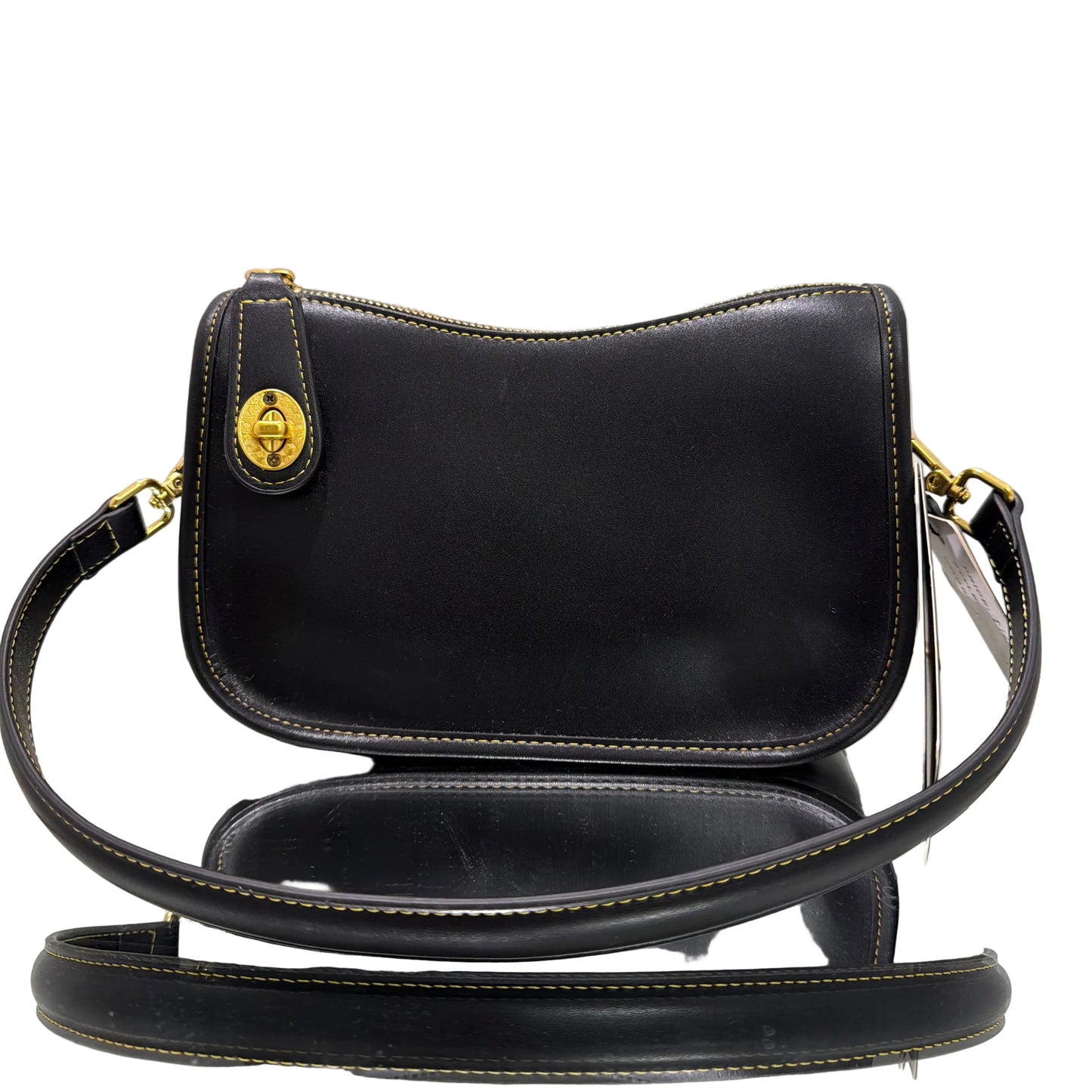 Black handbag with gold accents on a light gray background