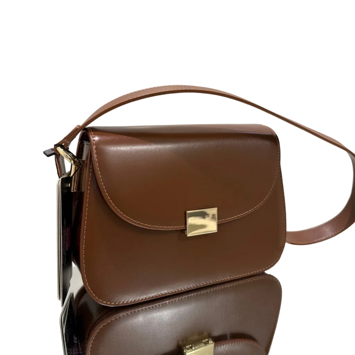 Brown leather handbag with gold clasp on a white background