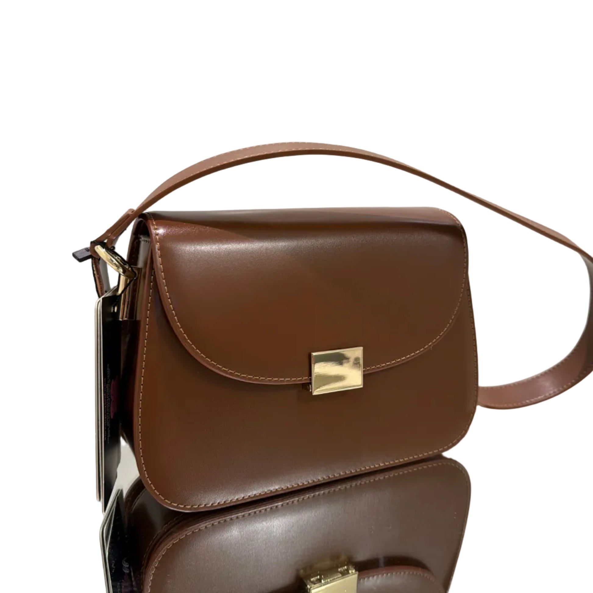 Brown leather handbag with gold clasp on a white background