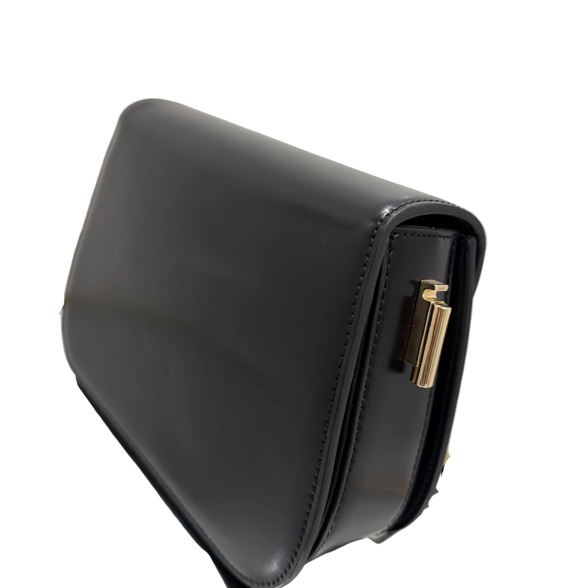 Black leather handbag with gold clasp on a light gray background