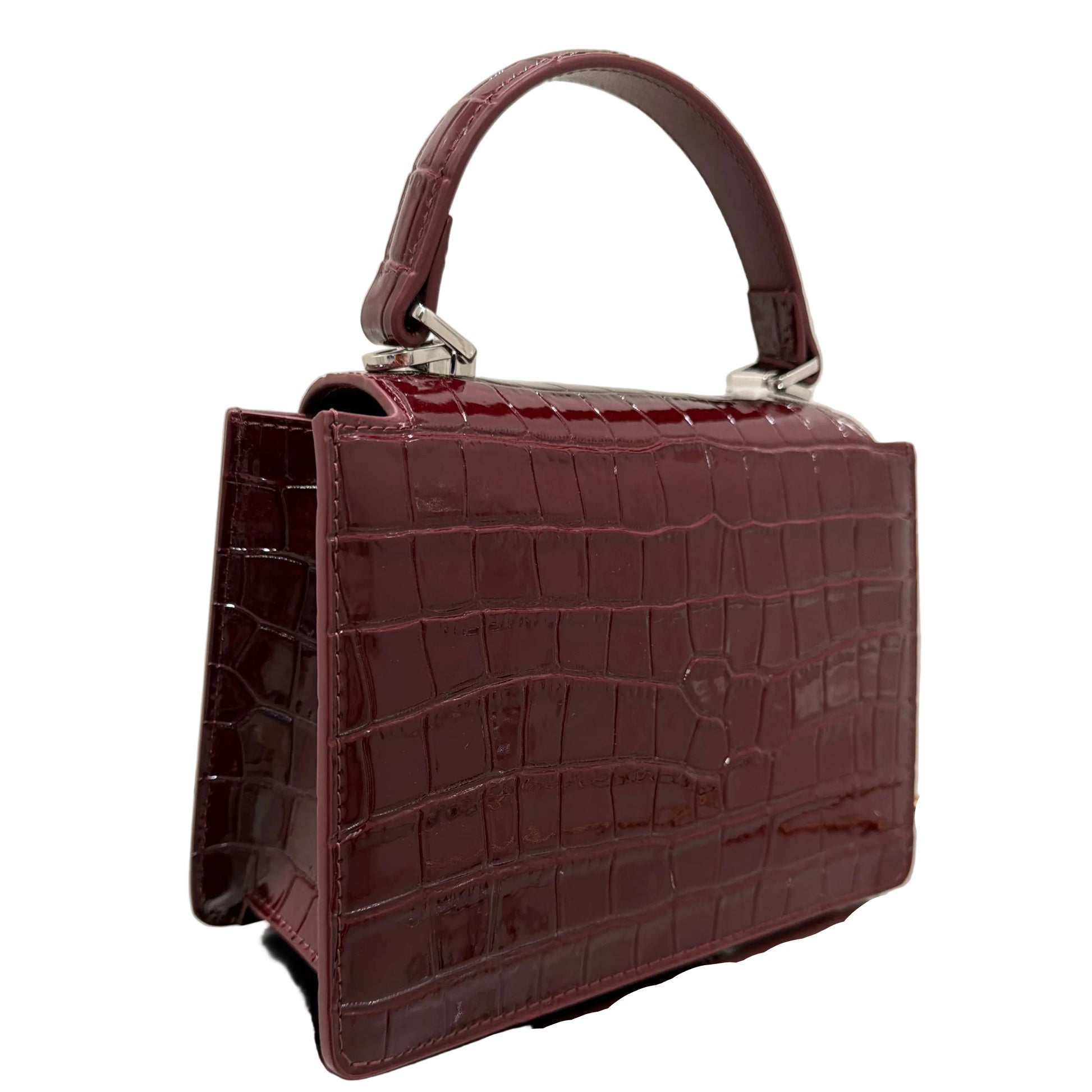 Brown crocodile-patterned handbag on a light background