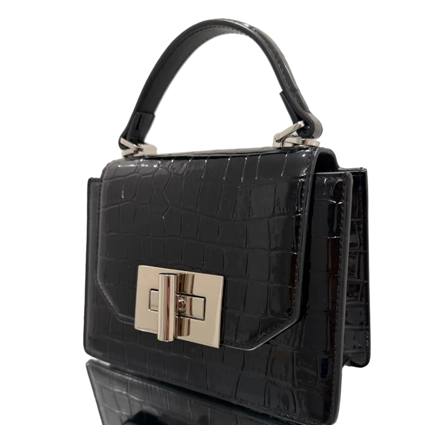 Black crocodile-patterned handbag with a silver clasp on a white surface
