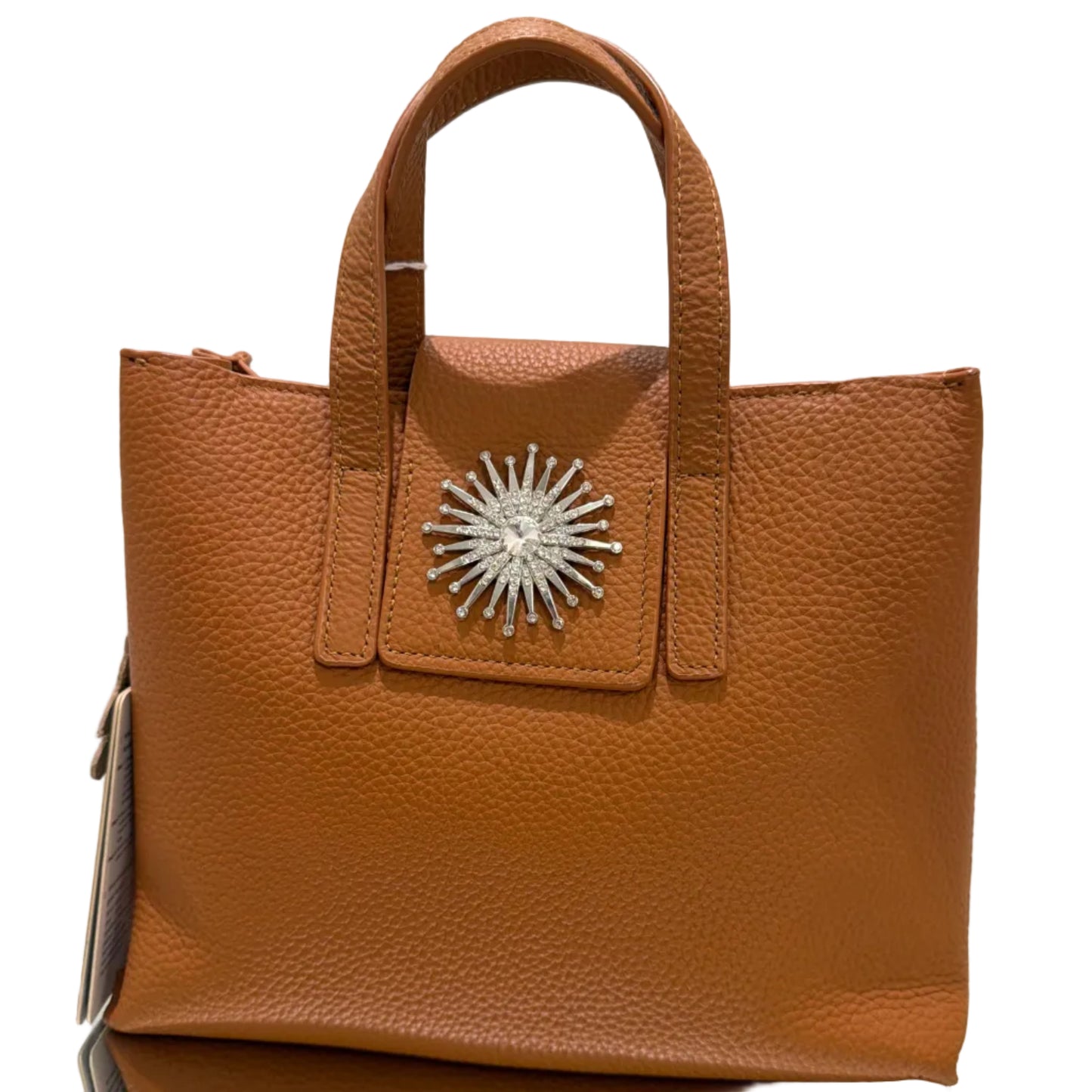 Brown leather handbag with a decorative silver emblem on a light background