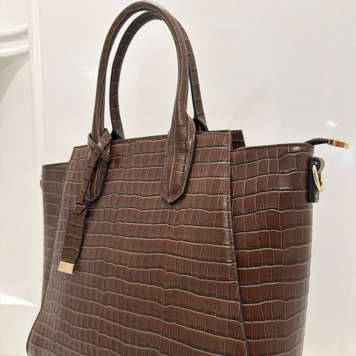 Brown textured handbag on a white background