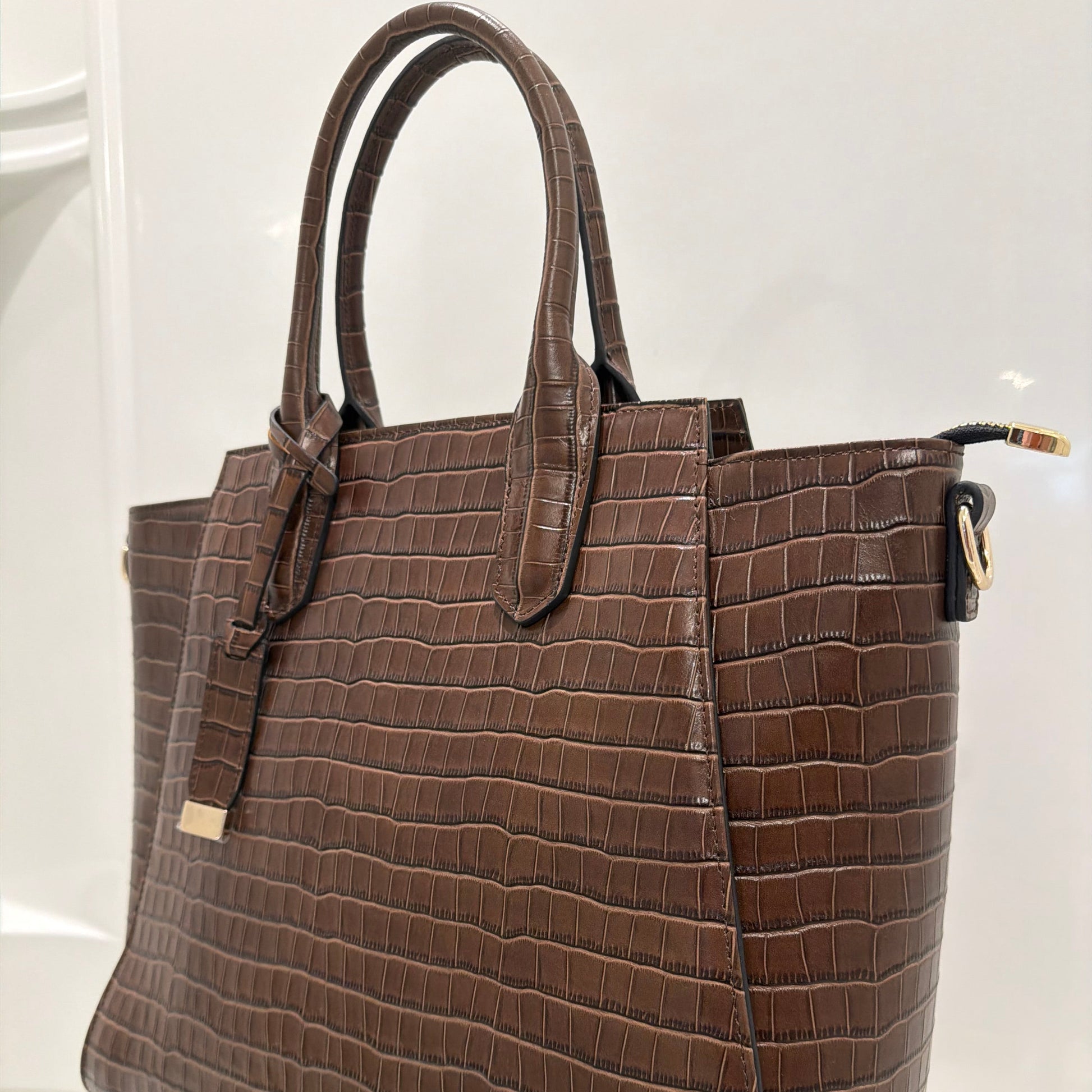 Brown textured handbag on a white background