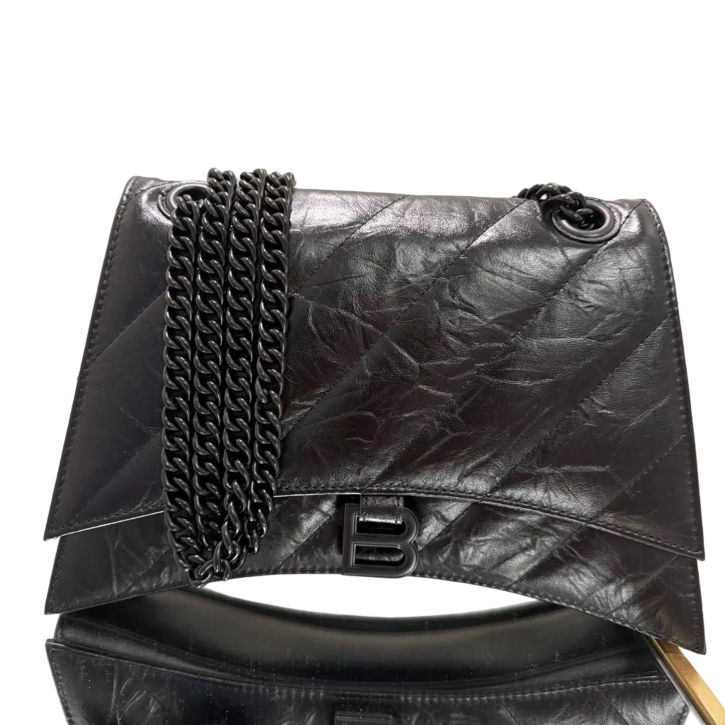 Black leather jacket with chain details on a beige background