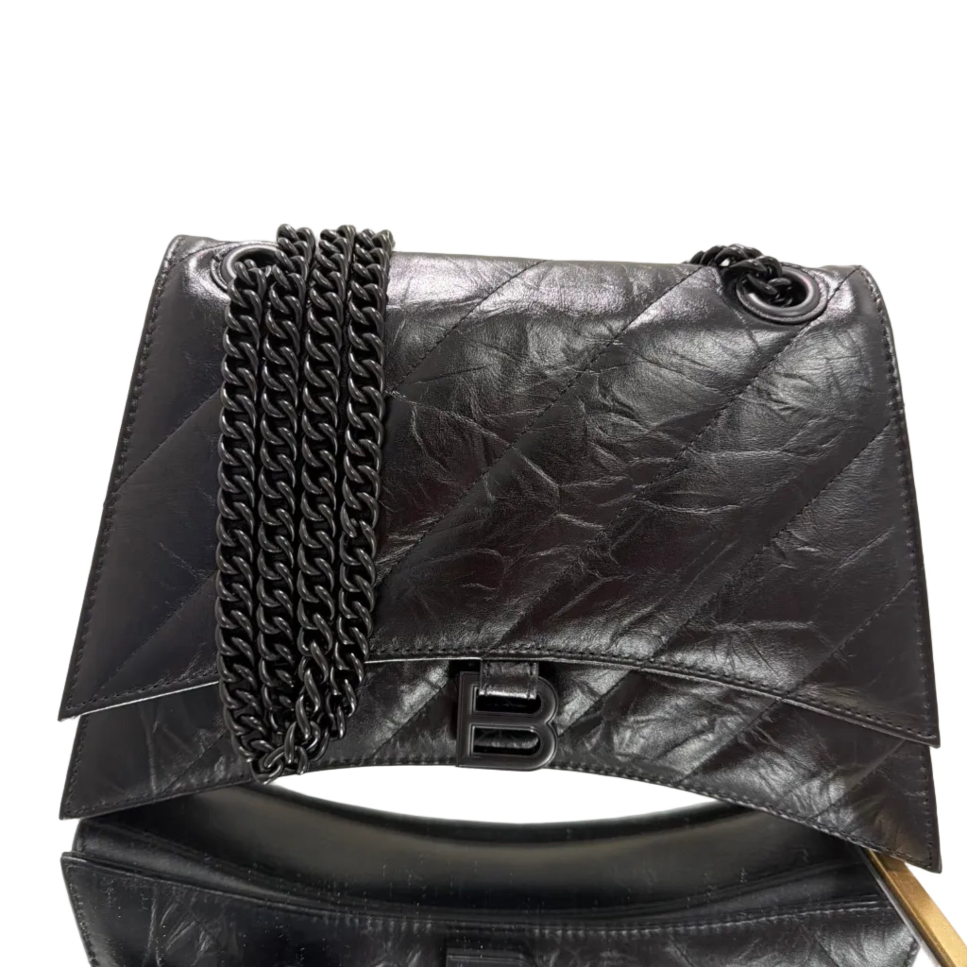 Black leather jacket with chain details on a beige background