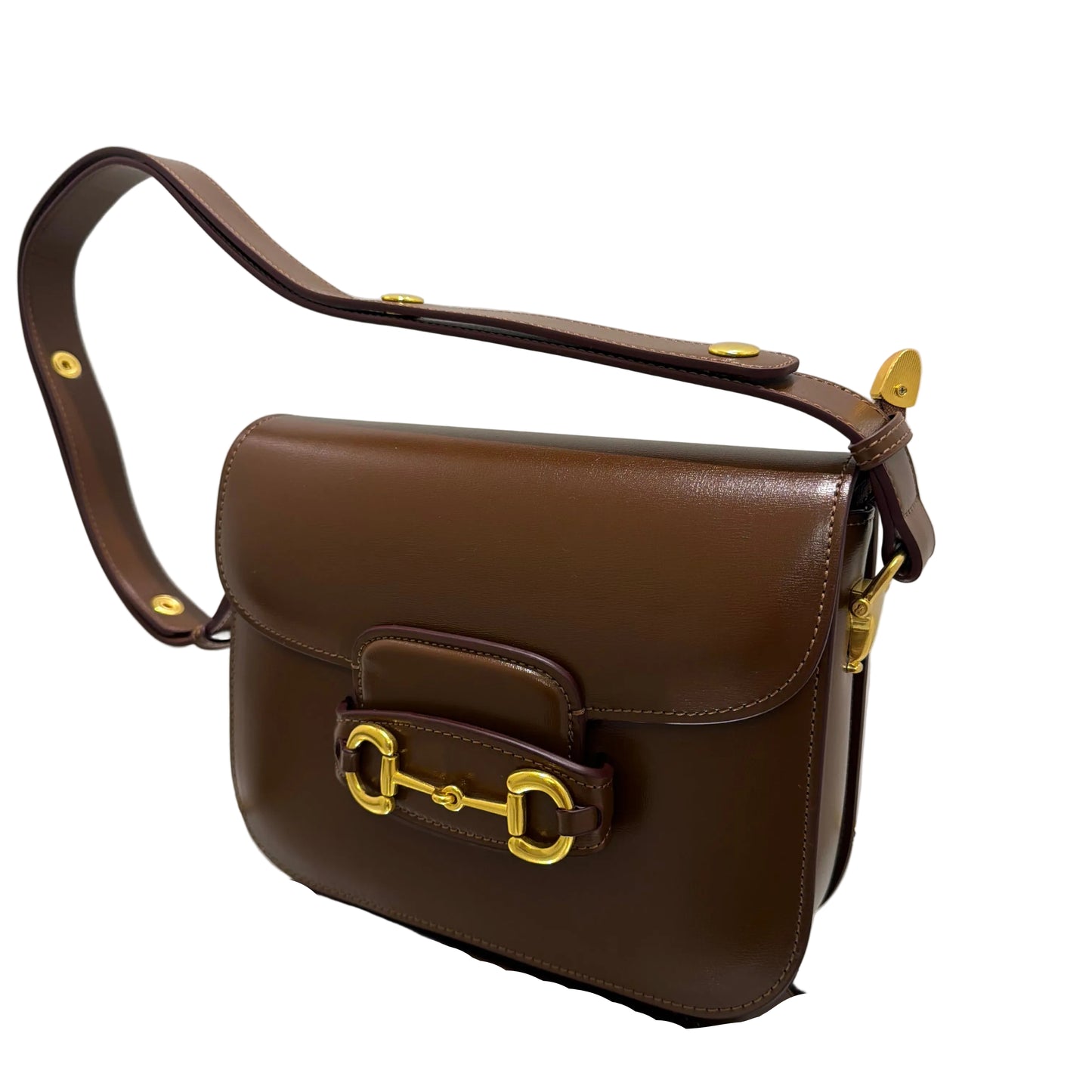 Brown leather handbag with gold hardware on a white background