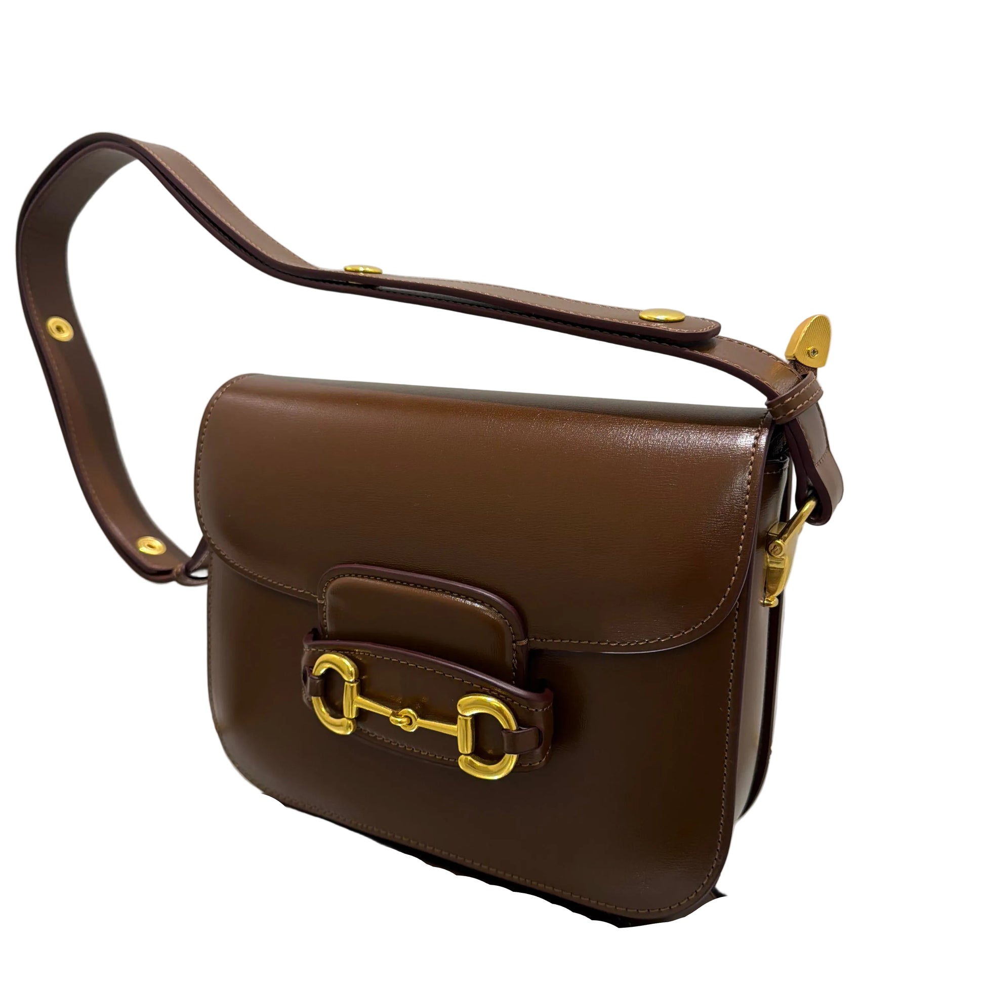 Brown leather handbag with gold hardware on a white background
