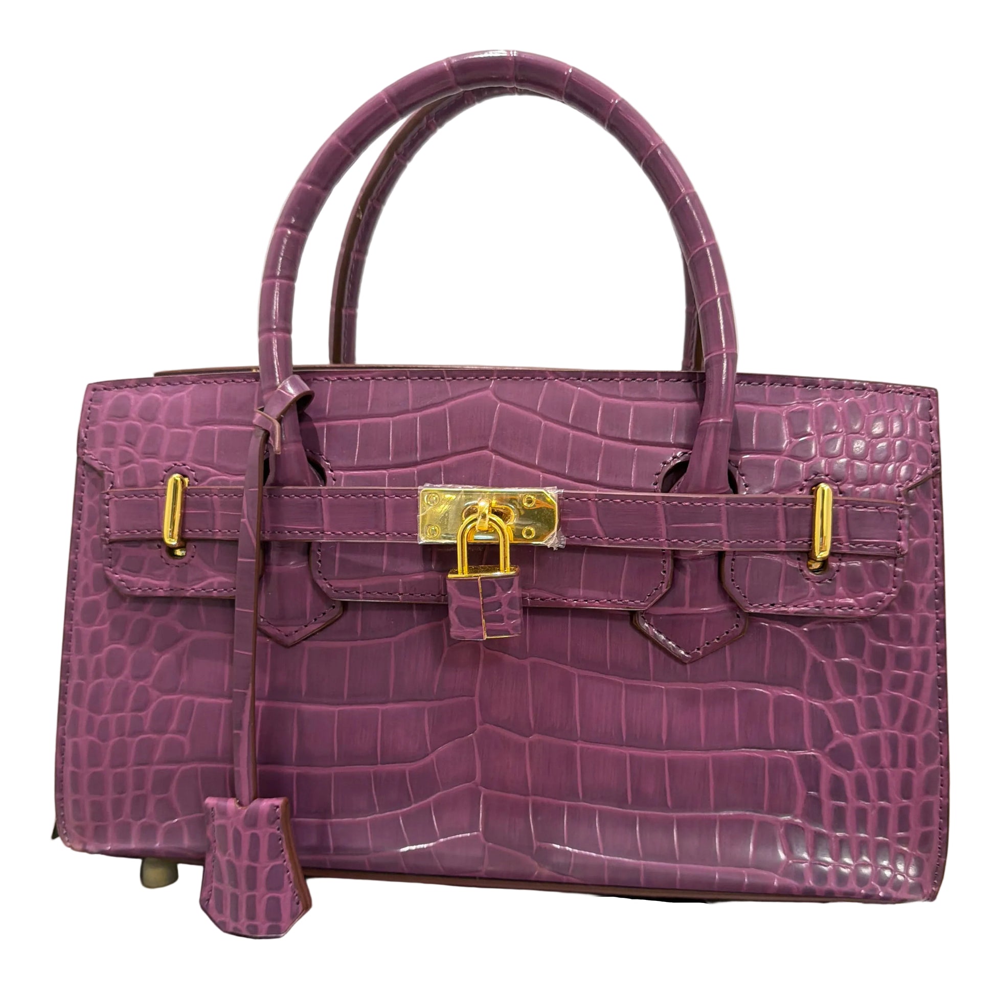 Purple crocodile skin handbag with gold hardware on a light gray background