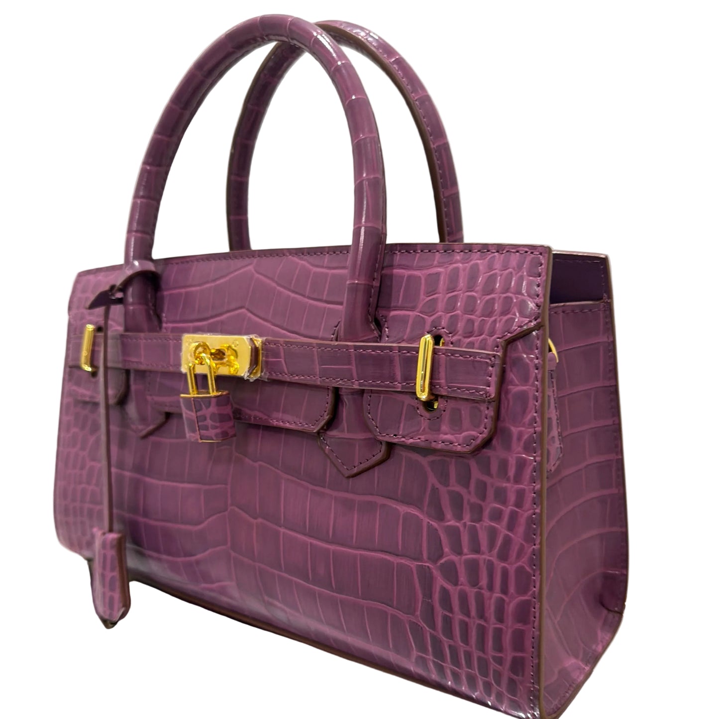 Purple textured handbag with gold accents on a white background