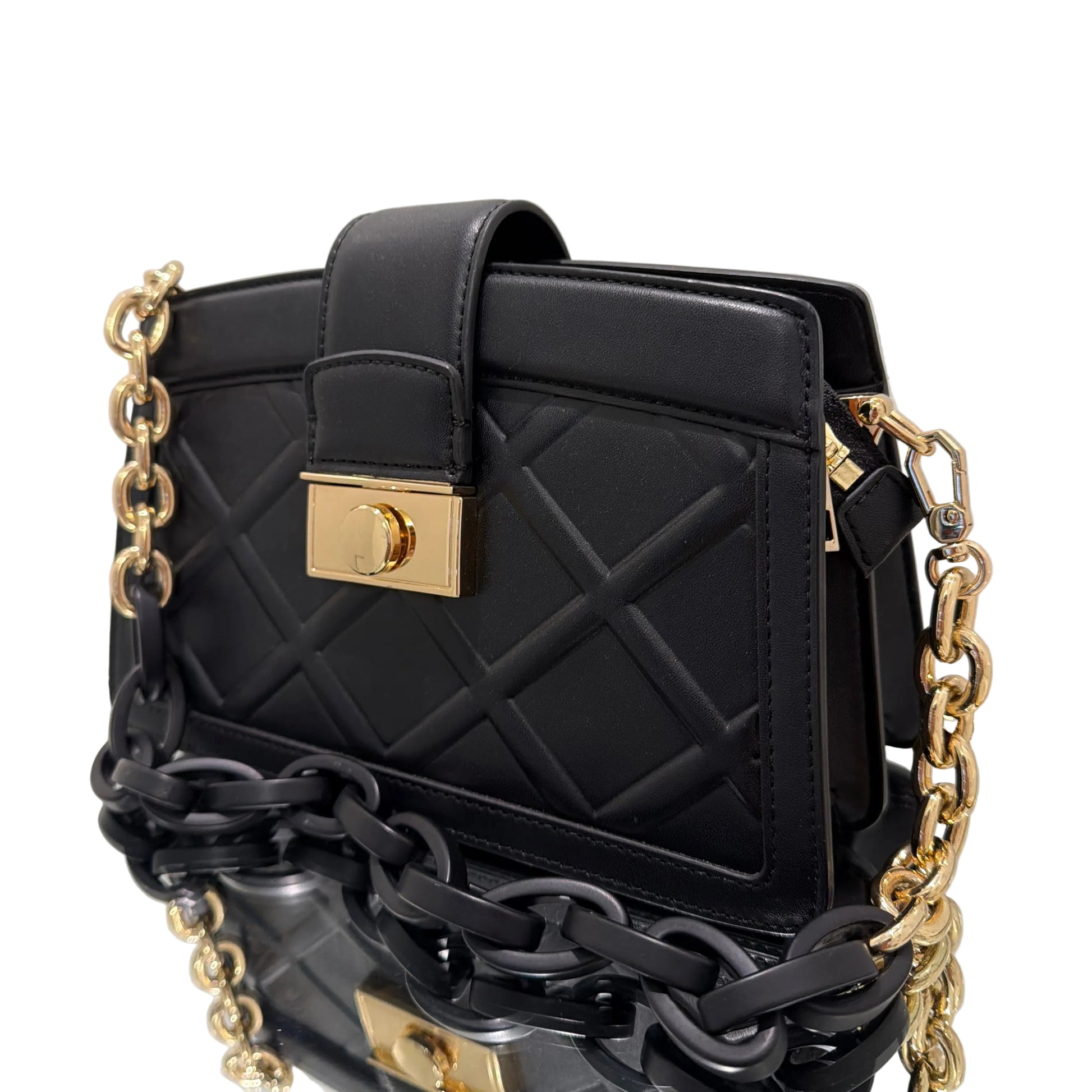 Black handbag with gold chain strap on a light gray background
