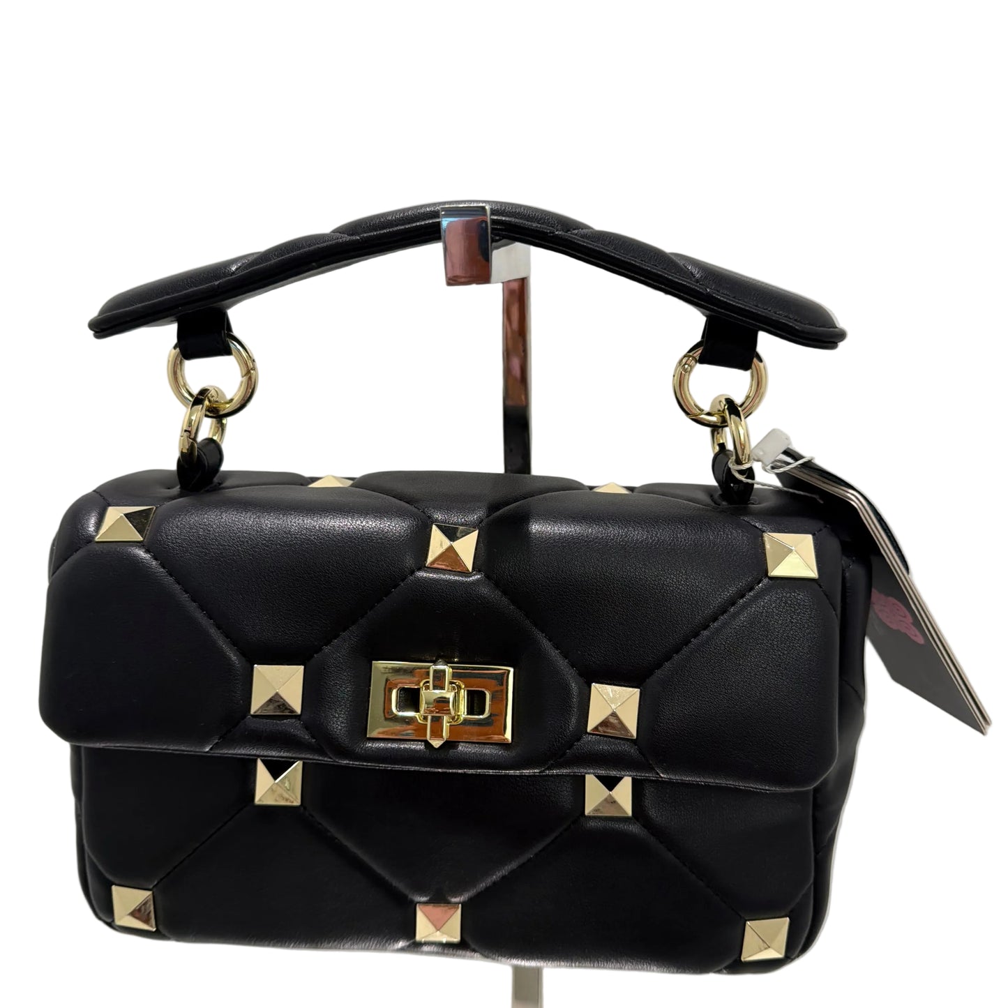 Black handbag with gold studs on a light gray background