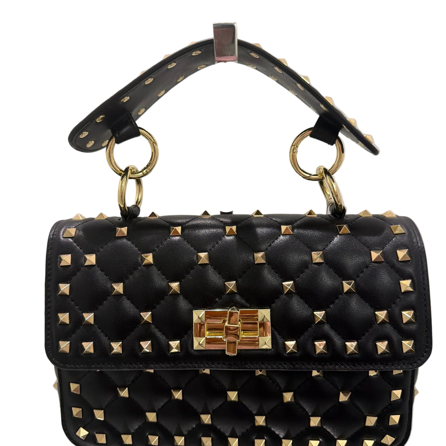 Black studded handbag with gold accents on a light gray background