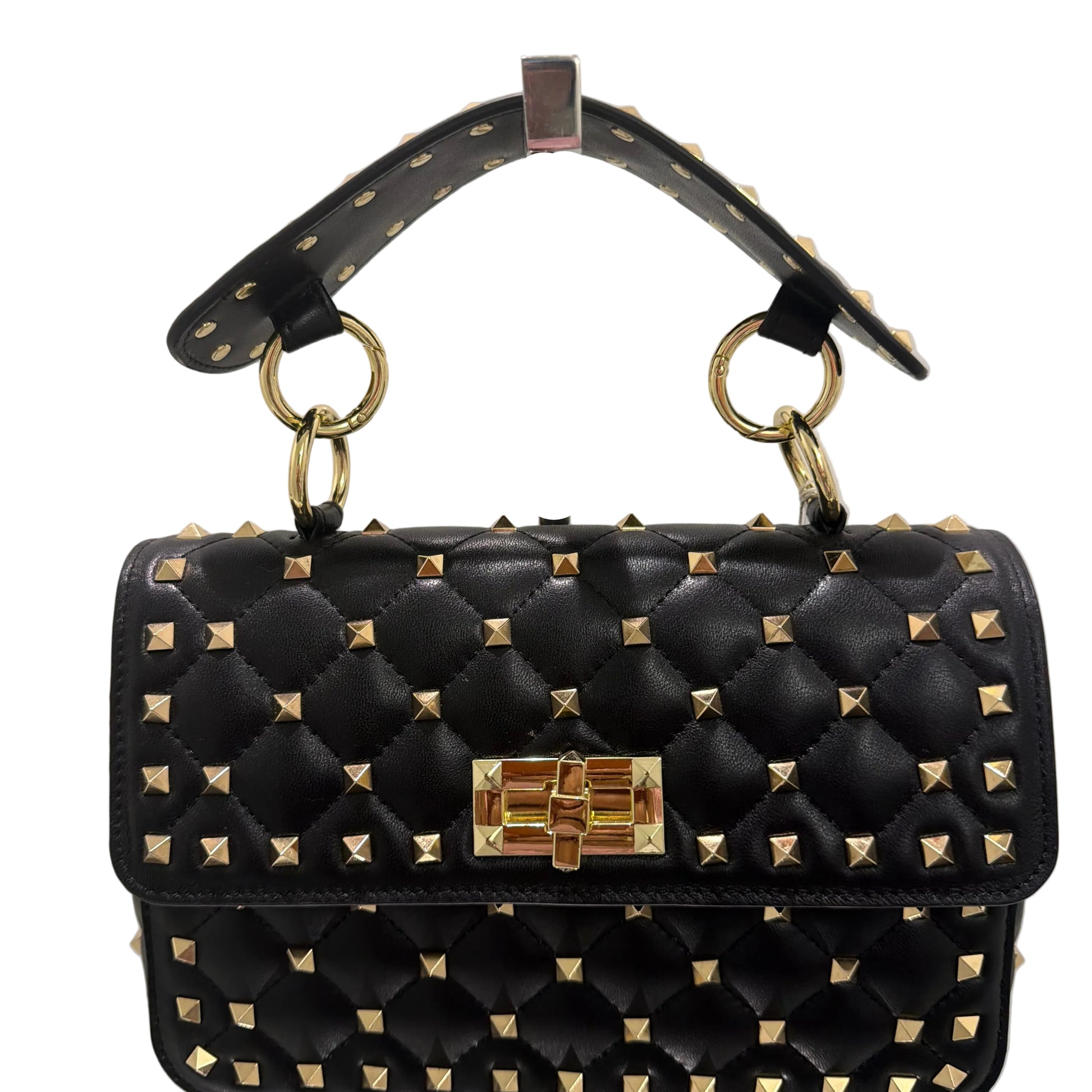 Black studded handbag with gold accents on a light gray background