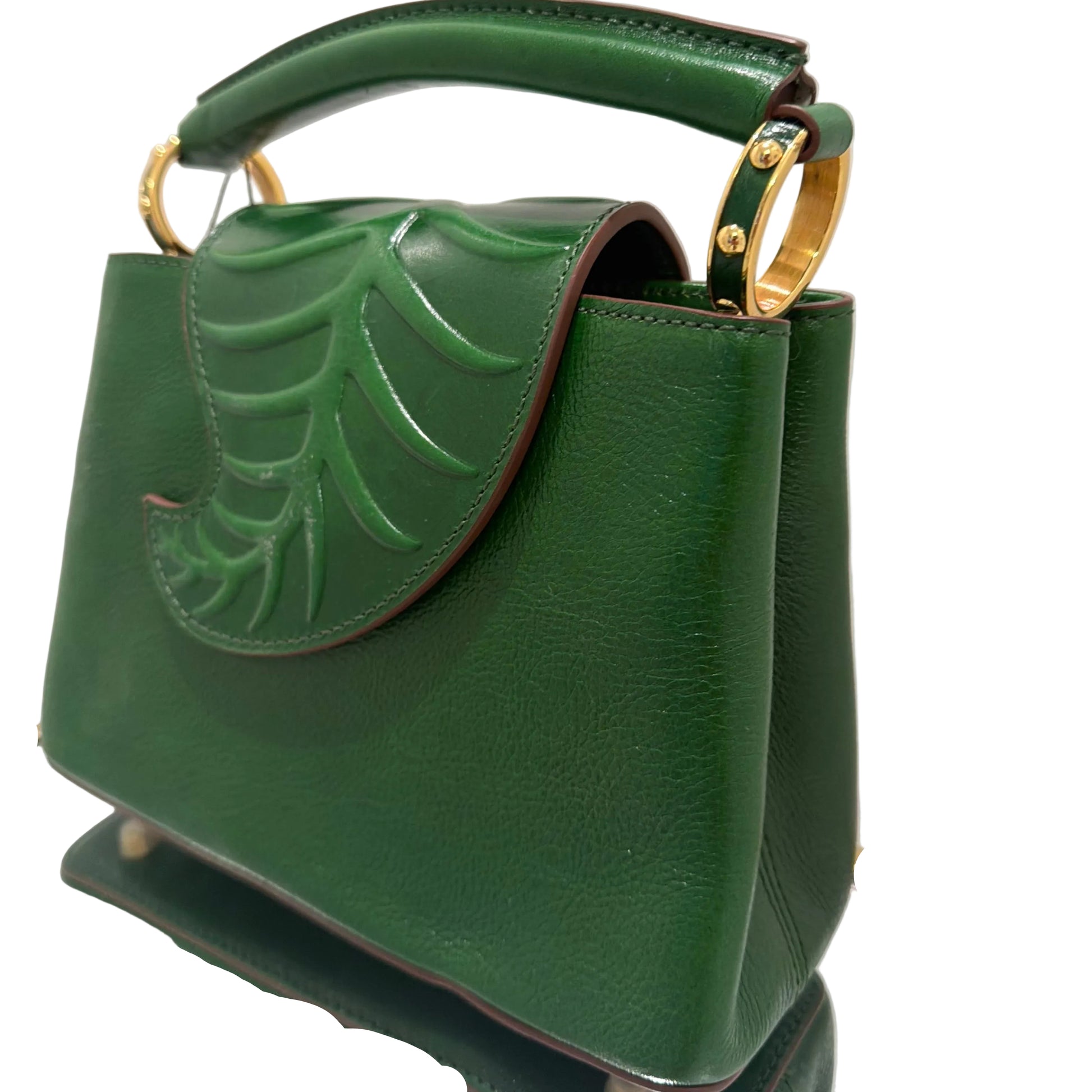 Green handbag with gold accents on a white background