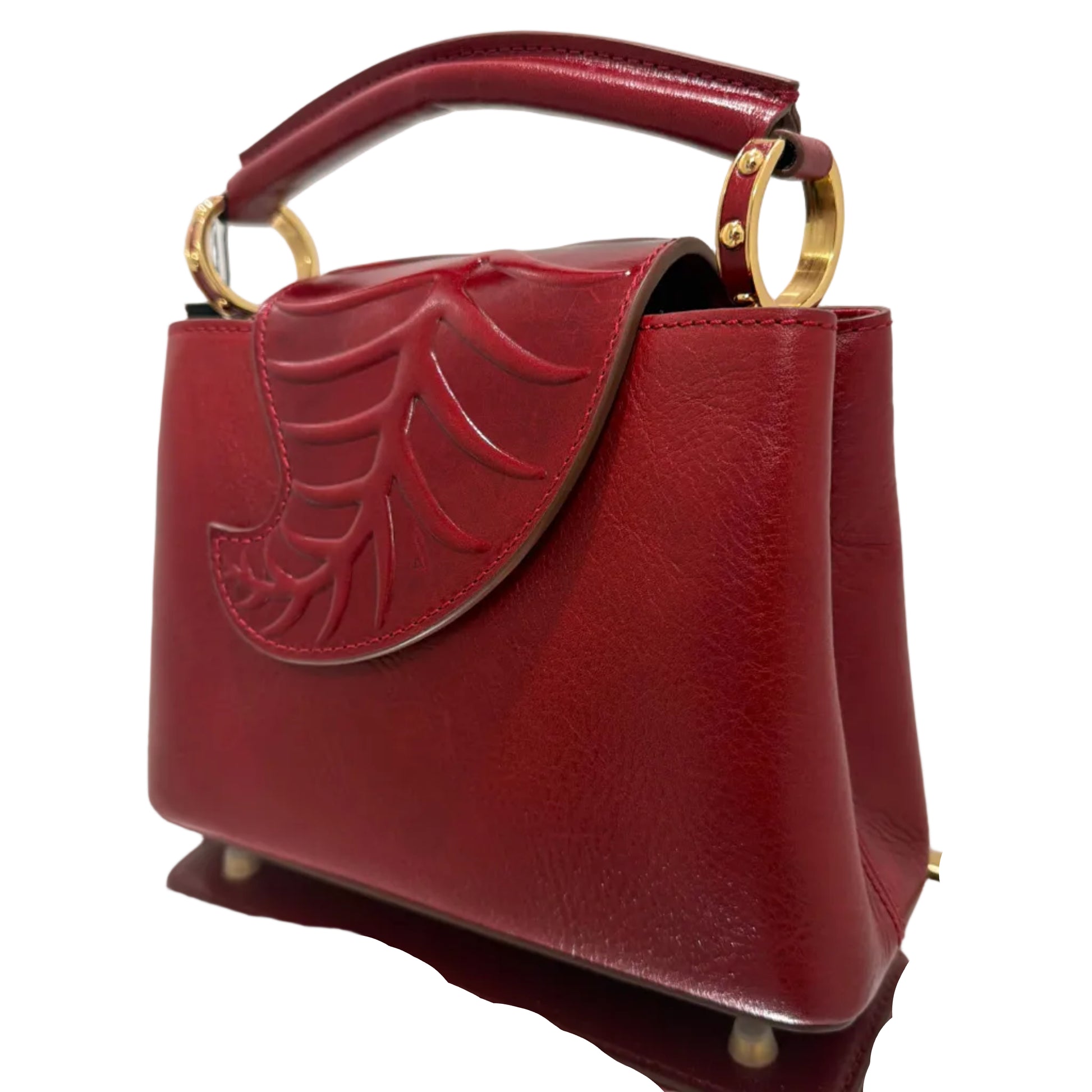 Red handbag with gold accents on a white background