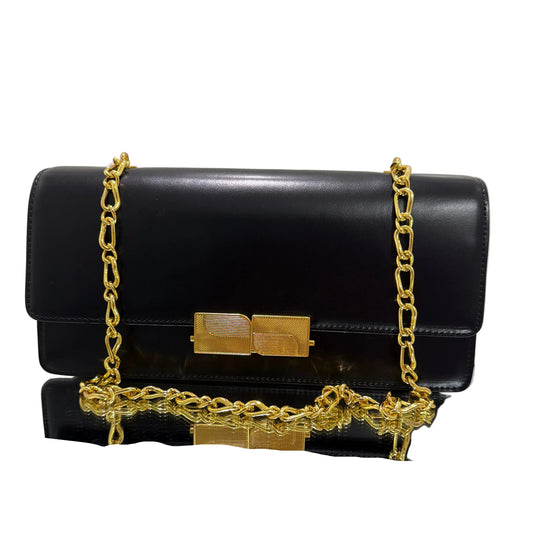 Black clutch bag with gold chain and lock on a light gray background