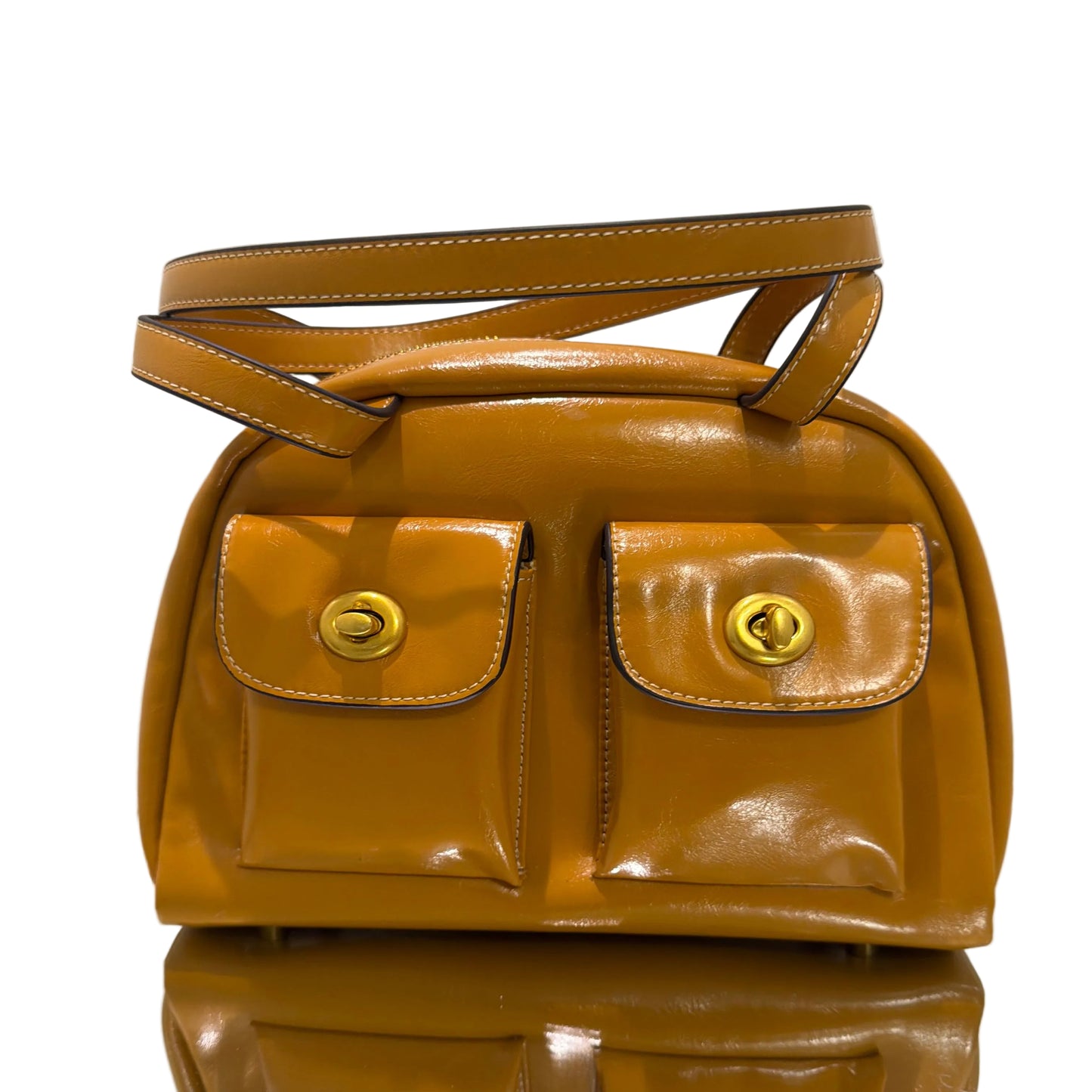 Brown leather bag with gold hardware on a white background