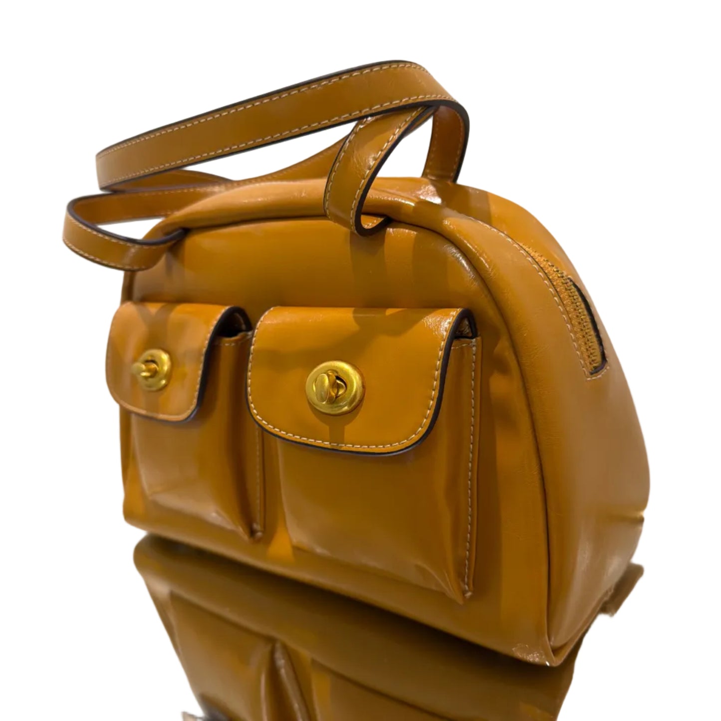 Brown leather bag with gold accents on a white background