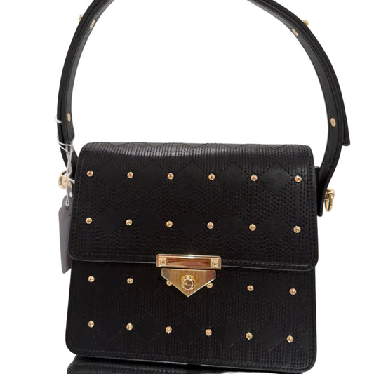 Black handbag with gold studs and a gold clasp on a light gray background