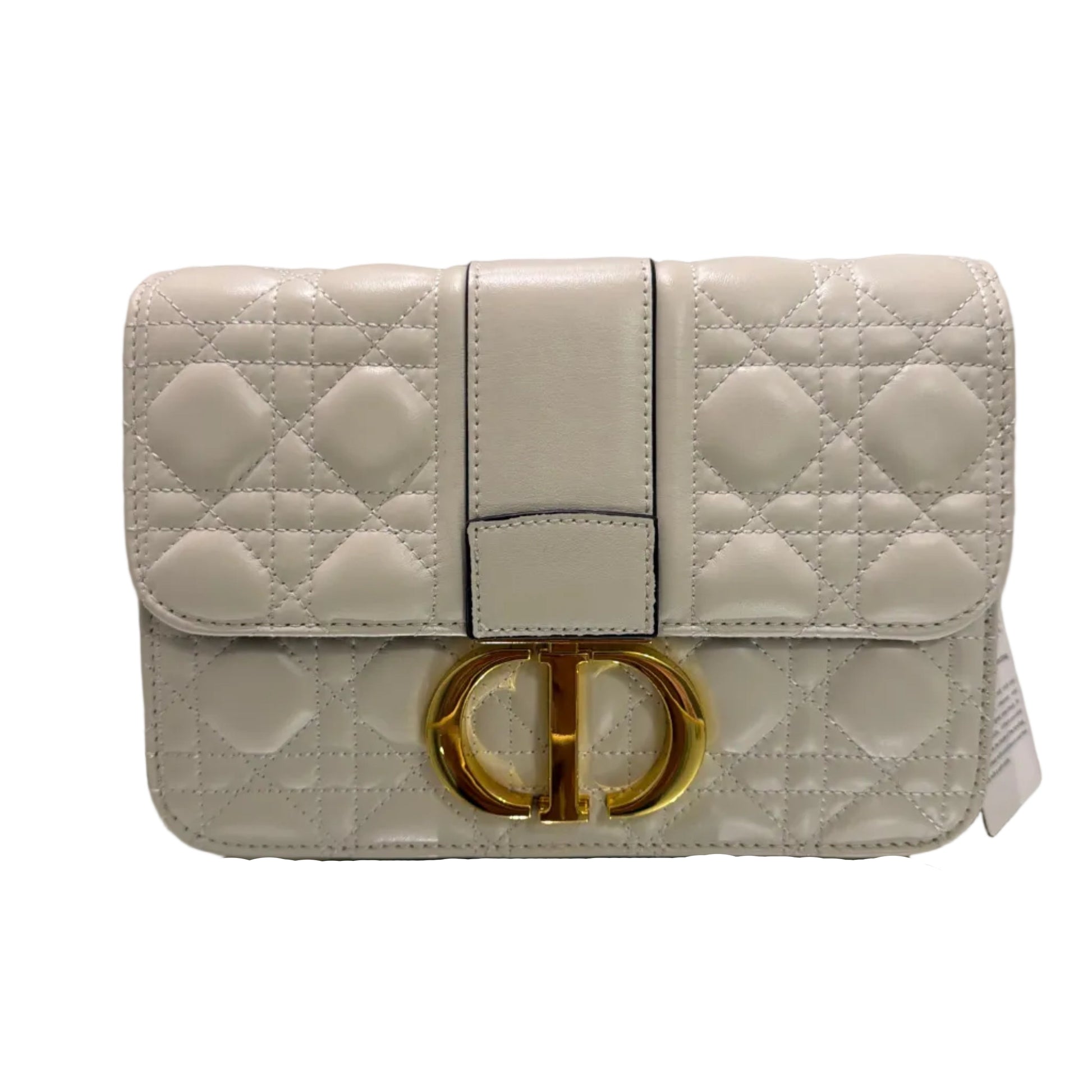 Quilted beige handbag with a gold buckle on a light gray background