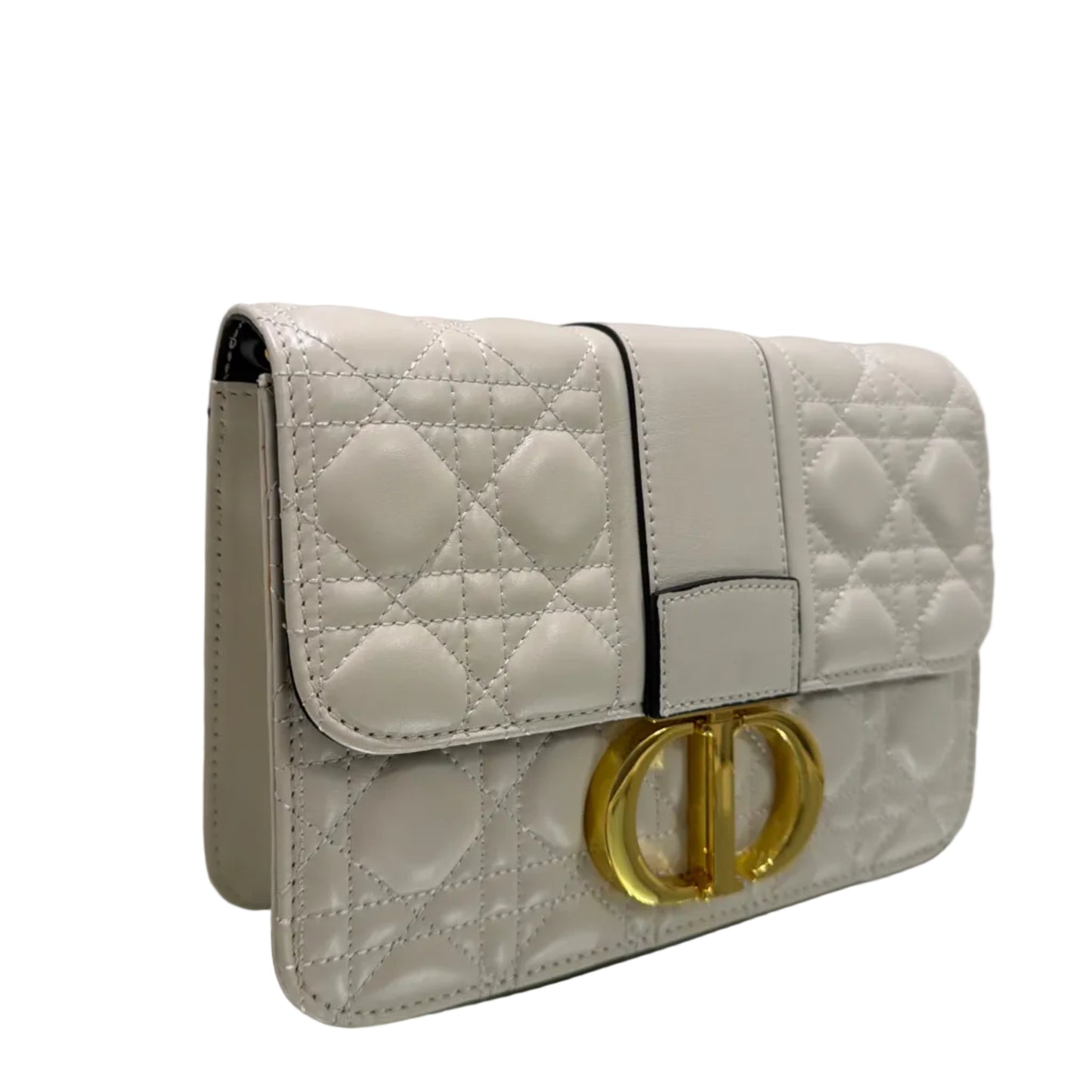White quilted handbag with gold buckles on a white background