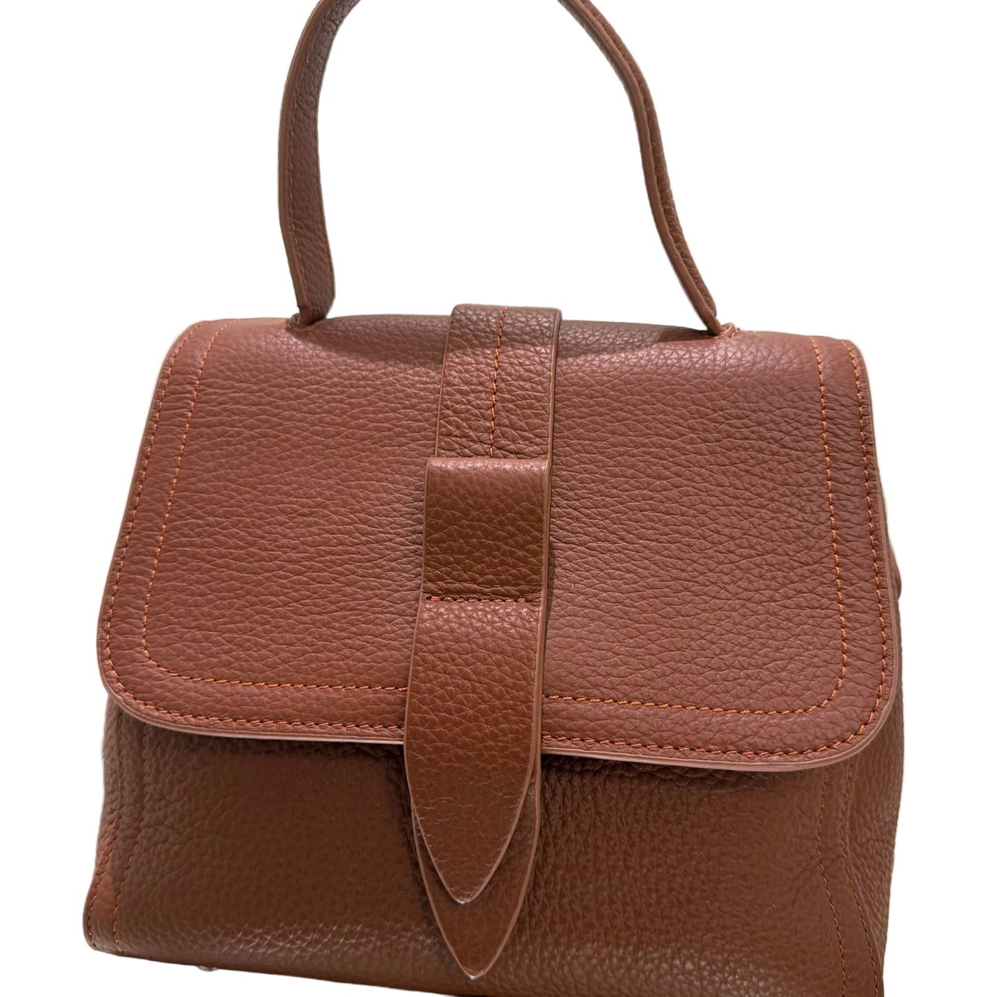 Brown leather bag with a strap on a light background