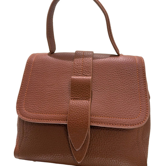 Brown leather bag with a strap on a light background