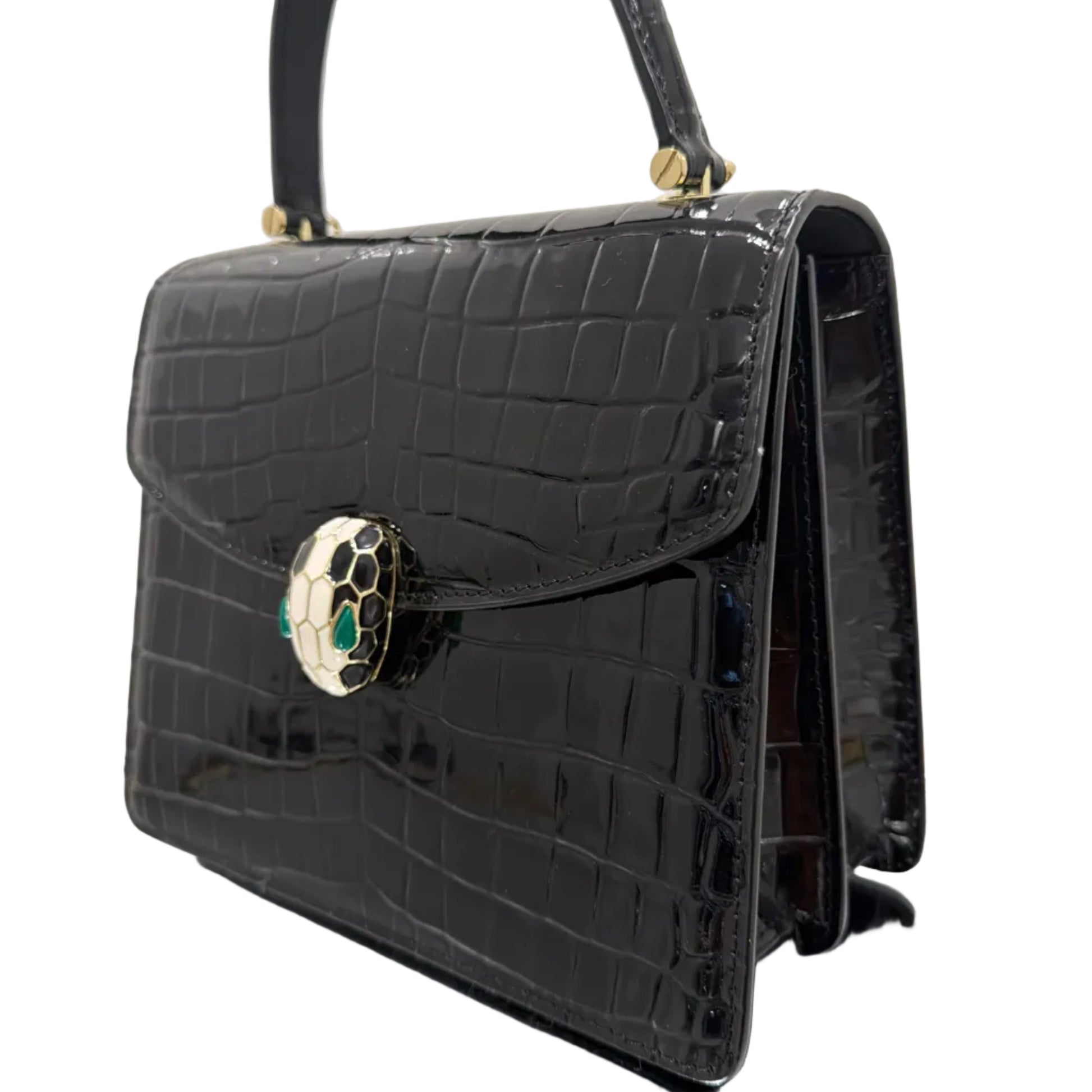 Black crocodile-patterned handbag with decorative clasp on a white background