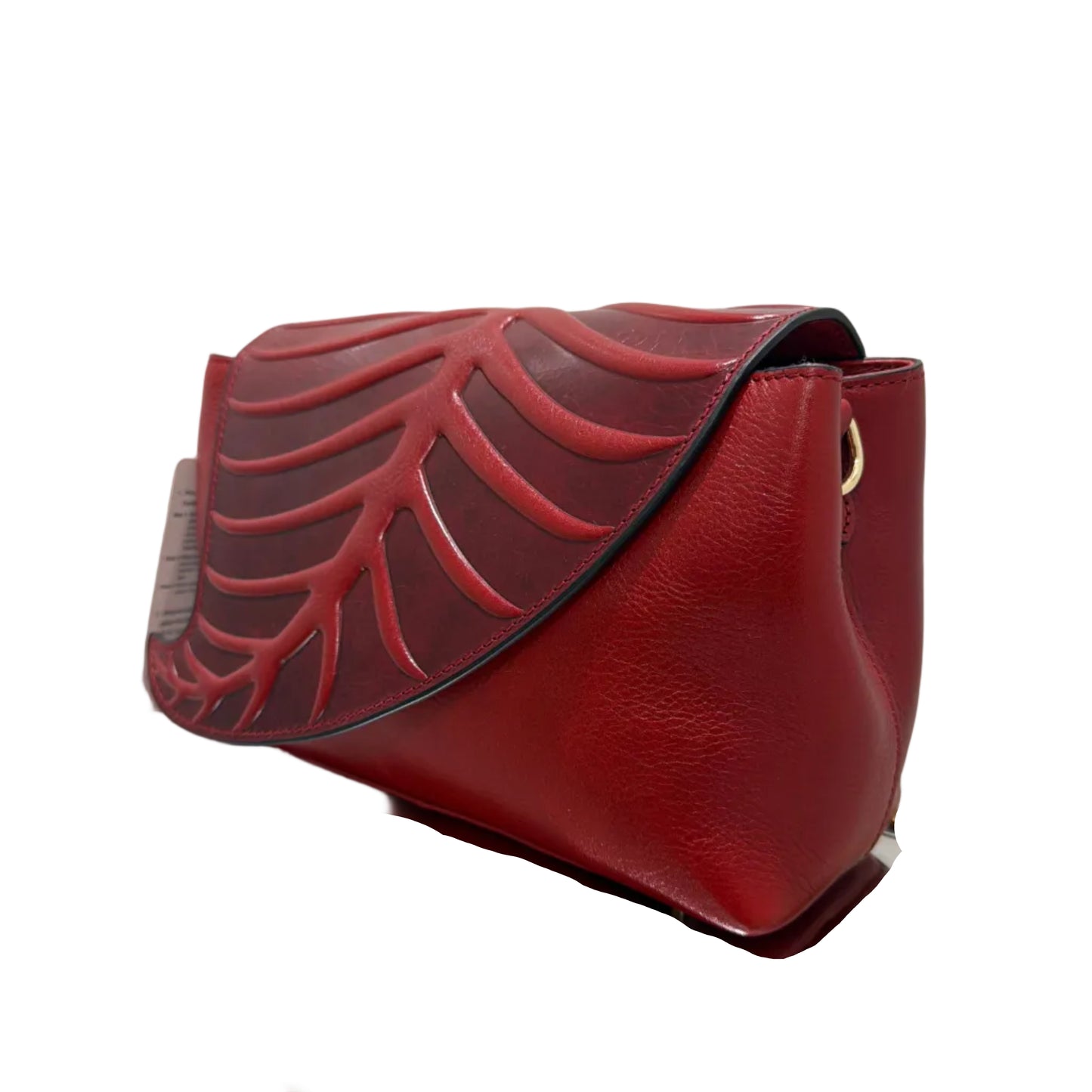 Red handbag with decorative patterns on a white background